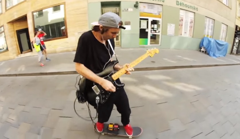 Thanks, Internet! Watch This Skater Roll Down The Street & Play “All Along The Watchtower”